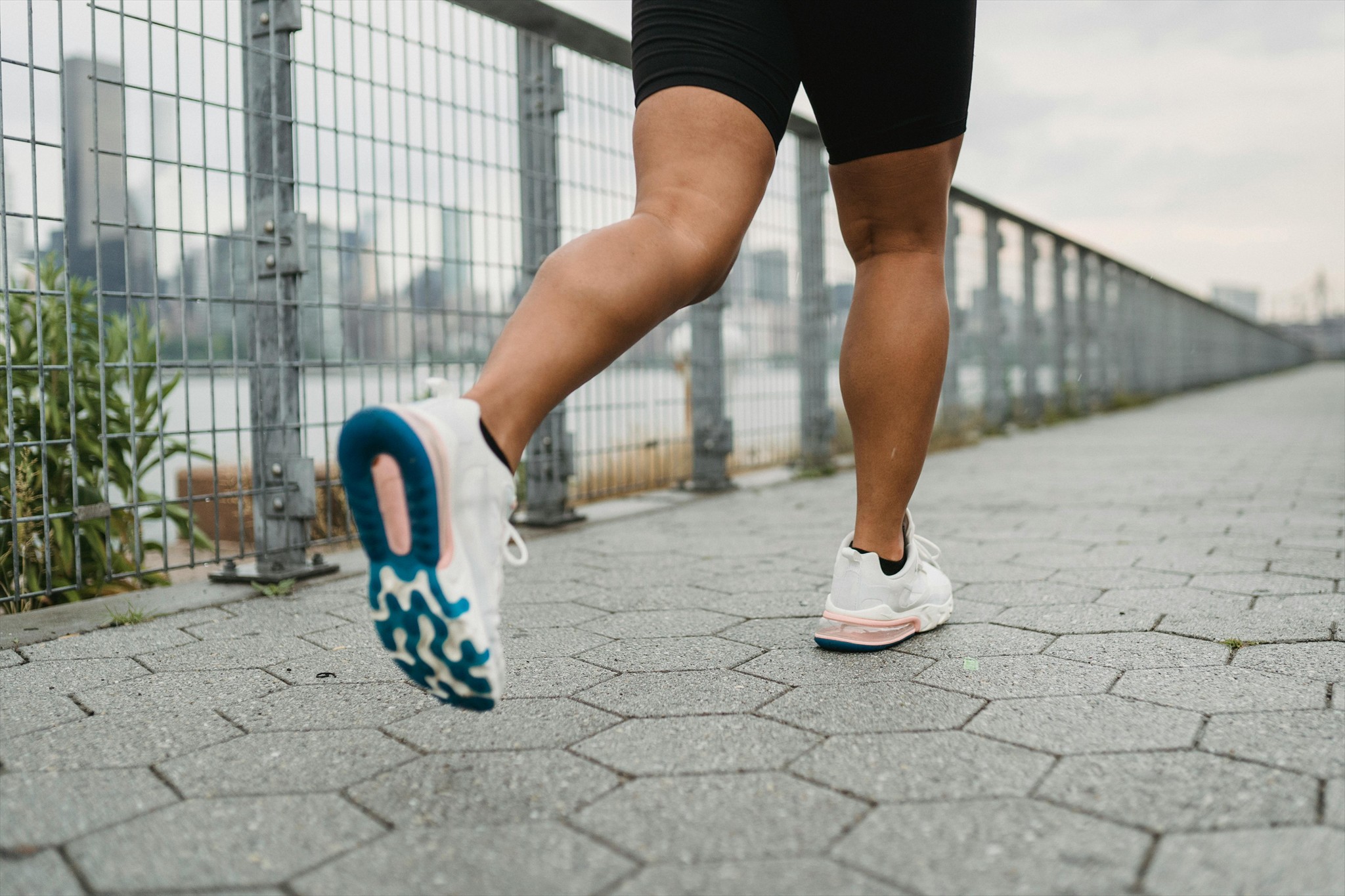 Person running on a trail with mountains in the background